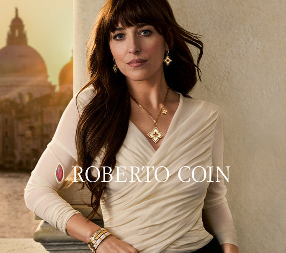 Woman wearing Roberto Coin jewelry with a cityscape in the background