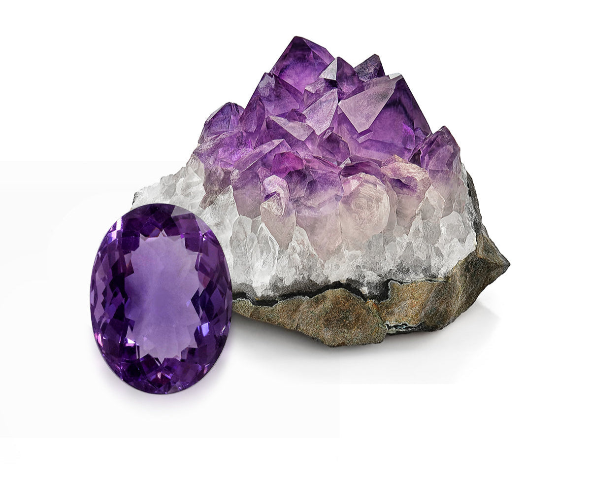 Purple amethyst crystal and gemstone on a white background