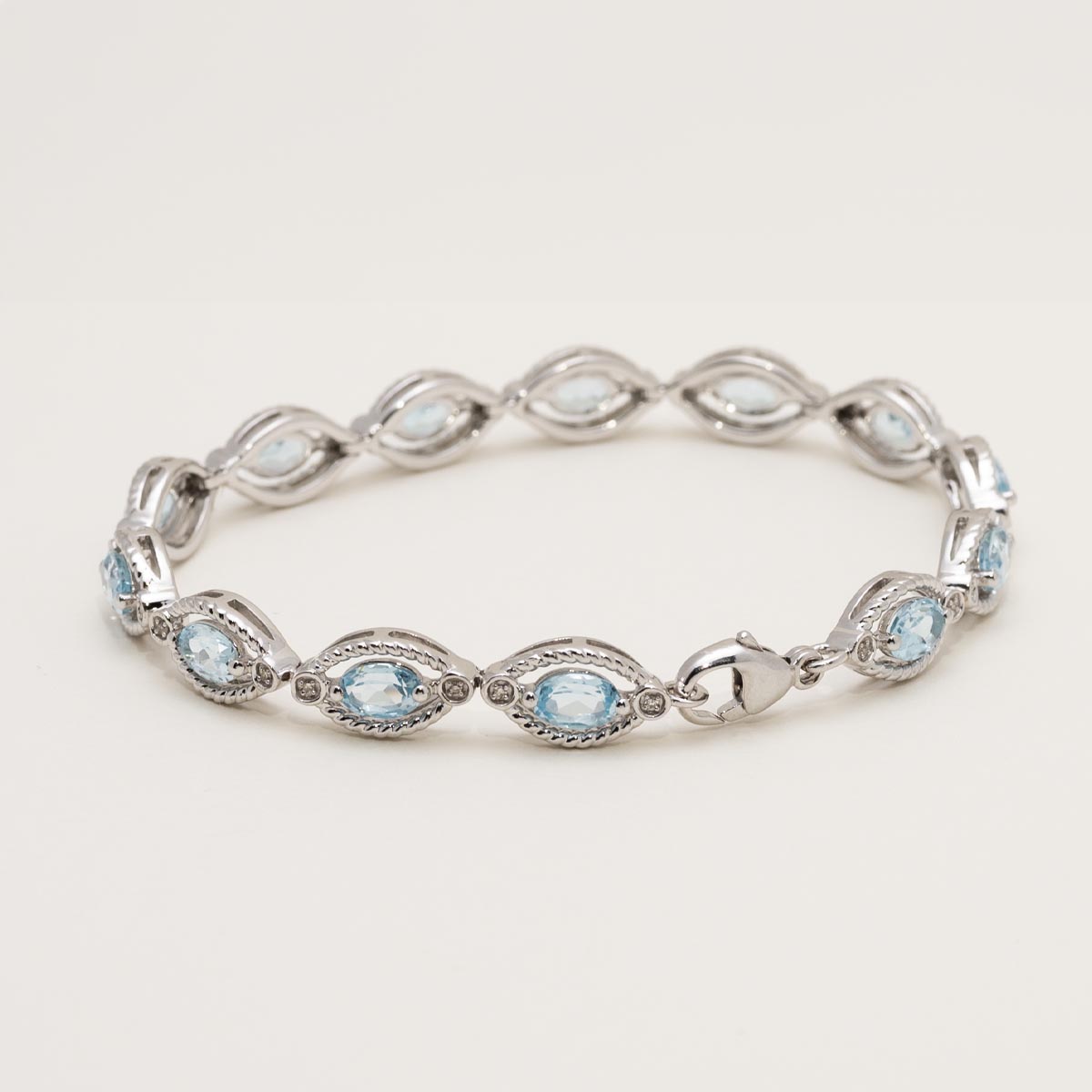 Oval Blue Topaz Bracelet in Sterling Silver with Diamonds (1/10ct tw)