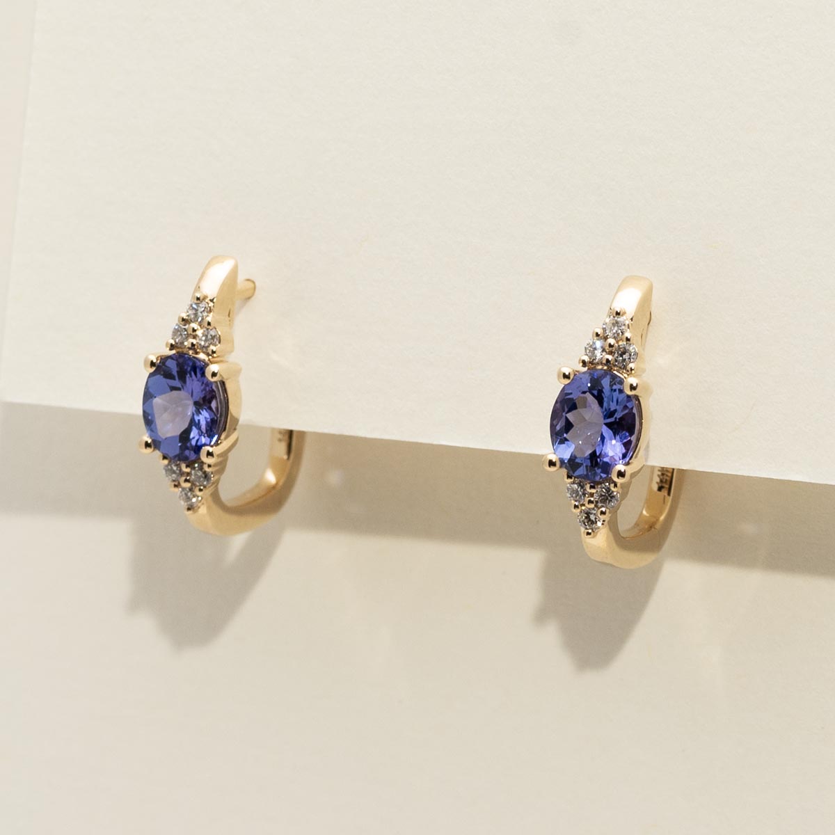 Oval Tanzanite and Diamond Hoop Earrings in 14kt Yellow Gold (1/7ct tw)
