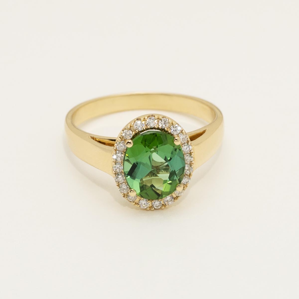 Oval Green Tourmaline Ring in 18kt Yellow Gold with Diamond Halo (1/7ct tw)