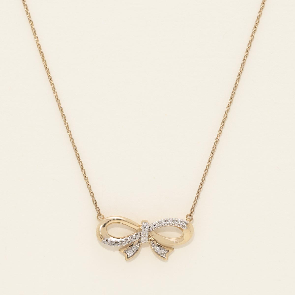 Diamond Bowtie Necklace in Sterling Silver with Yellow Gold Plating (1/10ct tw)