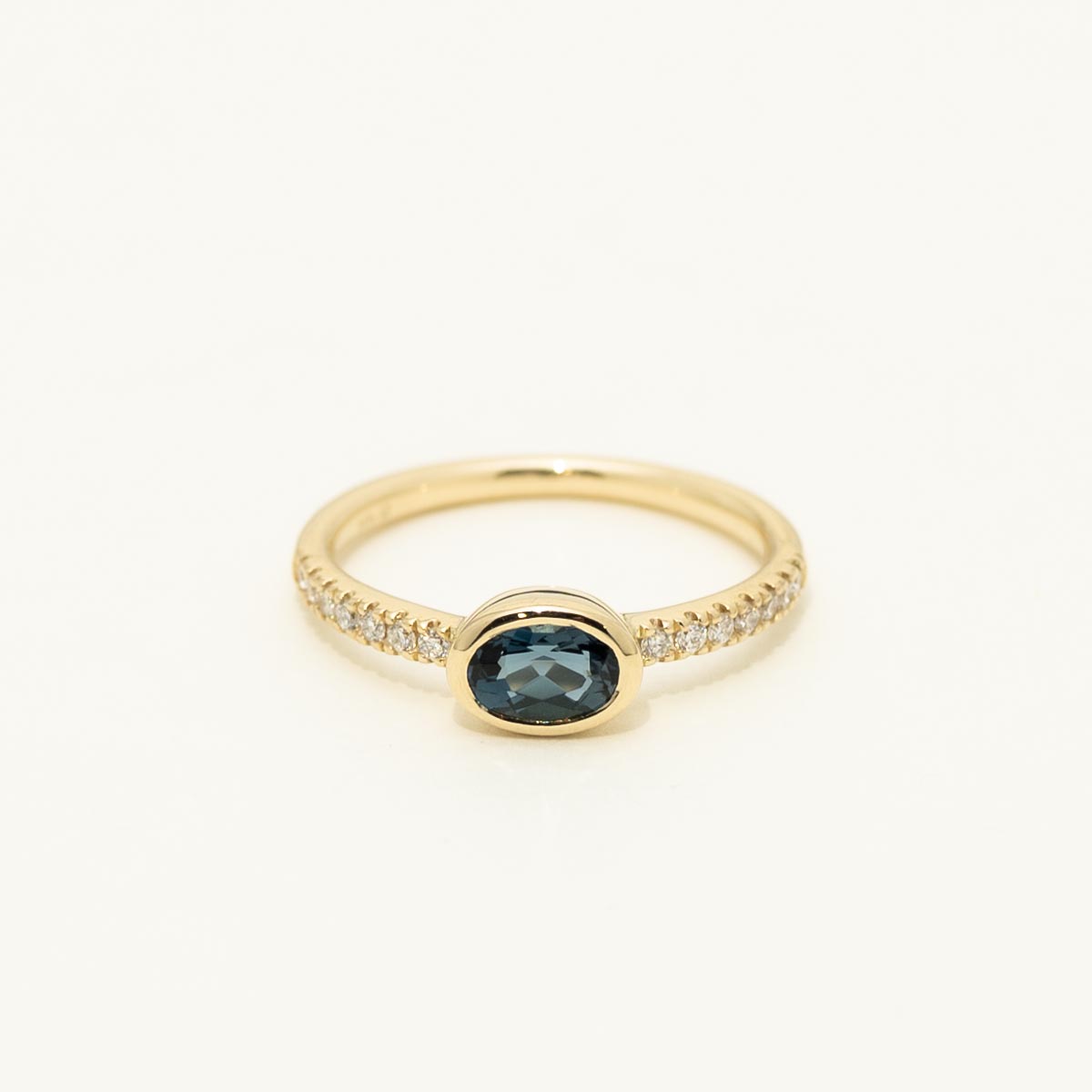 Oval London Blue Topaz Bezel Ring in 14kt Yellow Gold with Diamonds (1/7 ct tw)