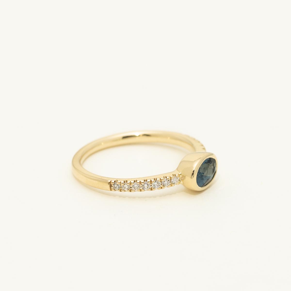 Oval London Blue Topaz Bezel Ring in 14kt Yellow Gold with Diamonds (1/7 ct tw)