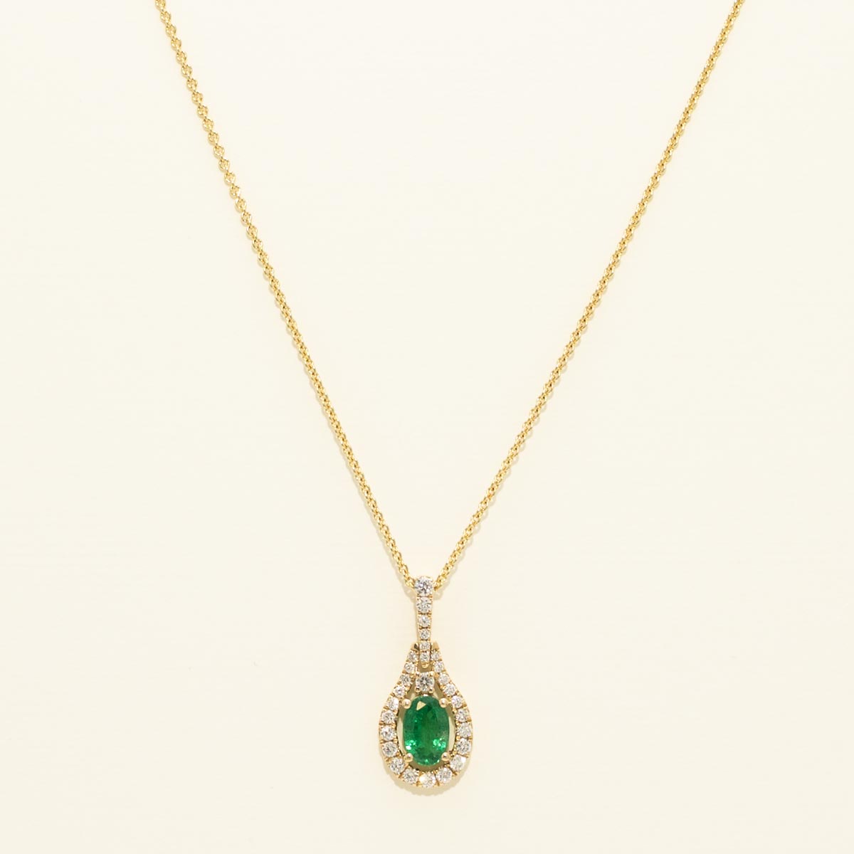 Oval Emerald Halo Necklace with Diamonds in 14kt Yellow Gold (1/5ct tw)
