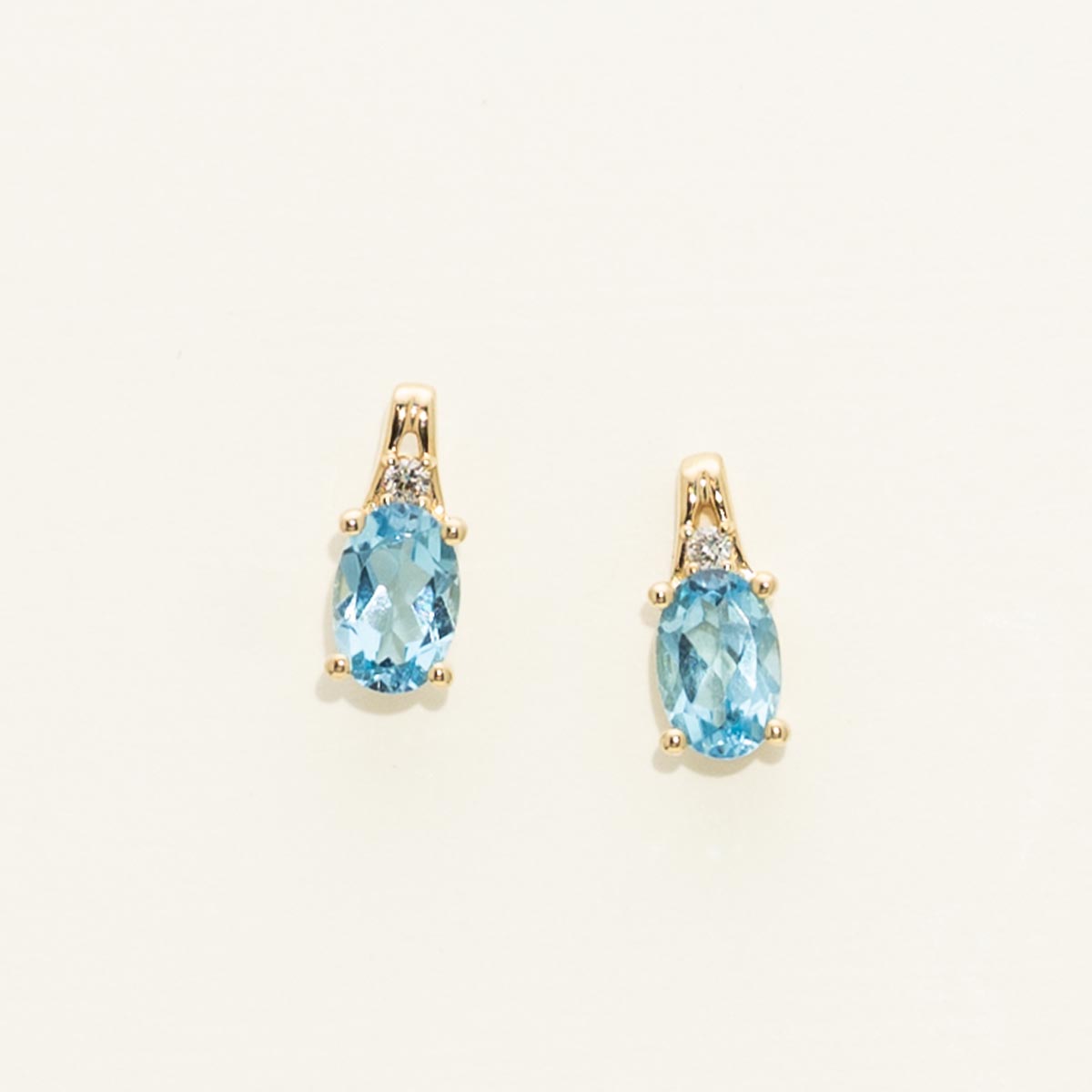 Oval Swiss Blue Topaz Earrings in 10kt Yellow Gold with Diamonds (.02ct tw)