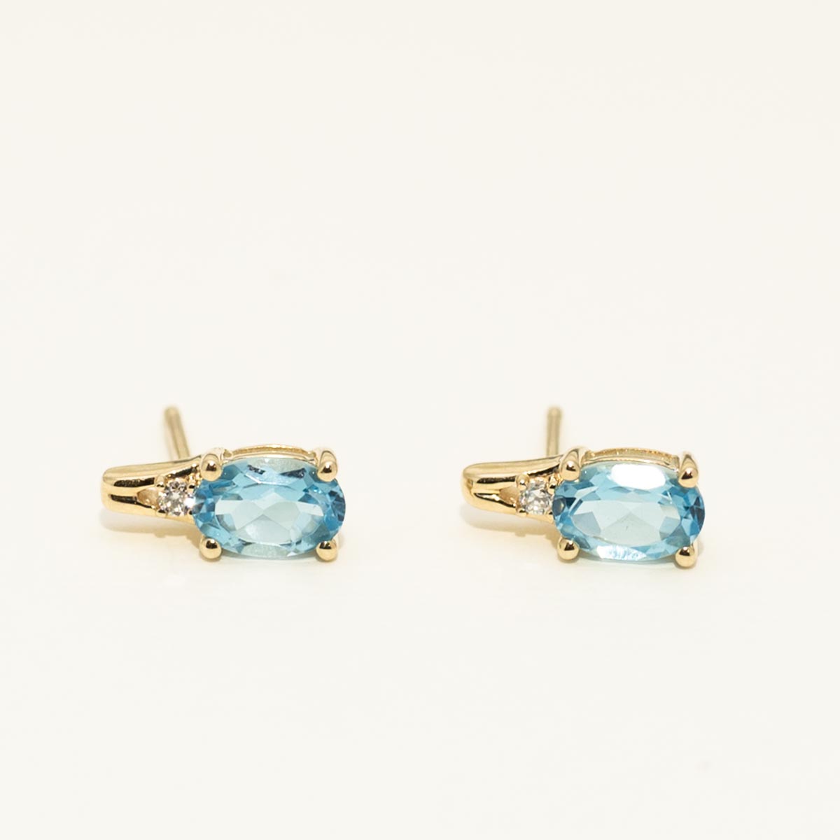 Oval Swiss Blue Topaz Earrings in 10kt Yellow Gold with Diamonds (.02ct tw)