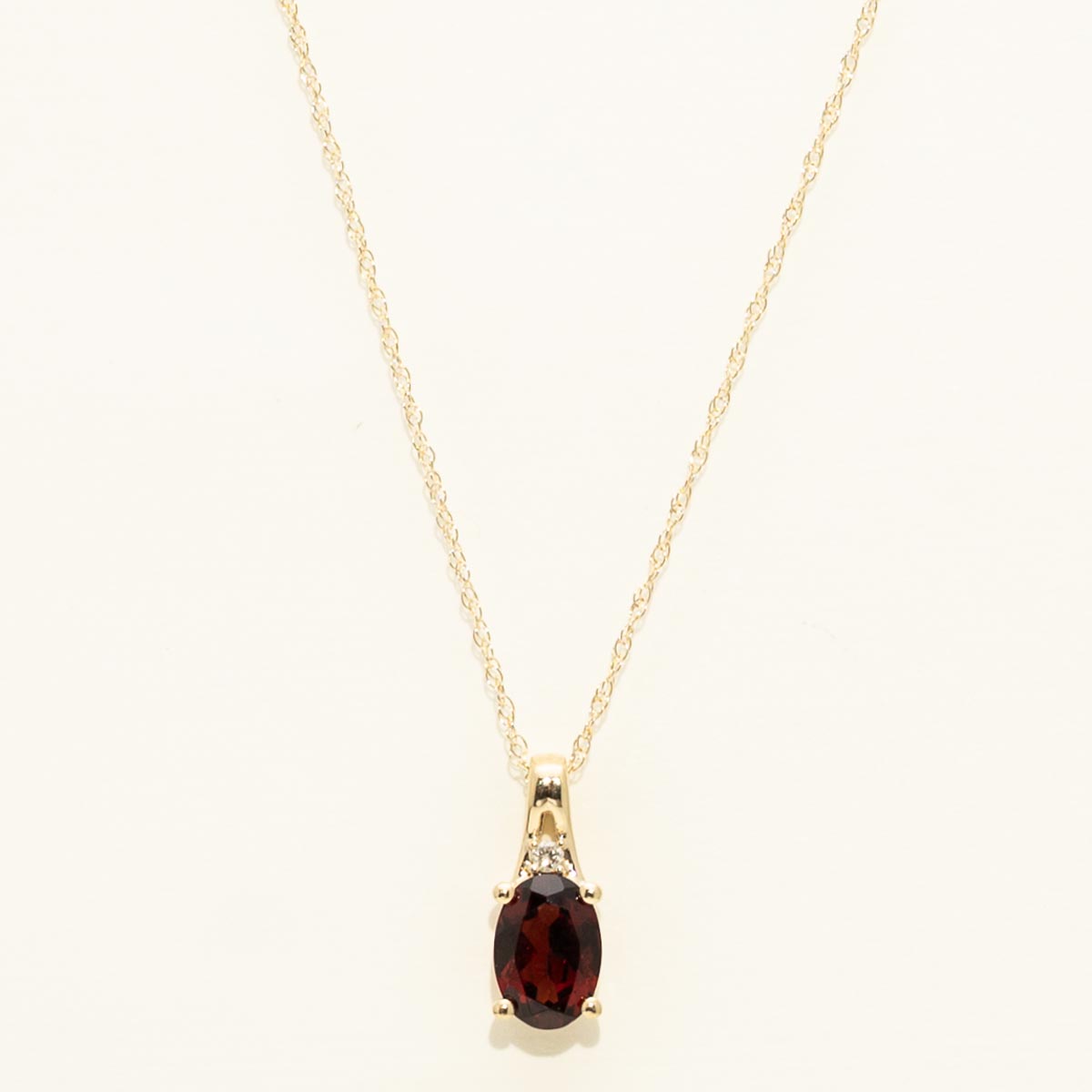 Oval Garnet Necklace in 10kt Yellow Gold with Diamond (.01ct)