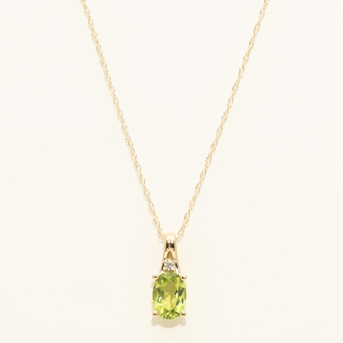 Oval Peridot Necklace in 10kt Yellow Gold with Diamond (.01ct)