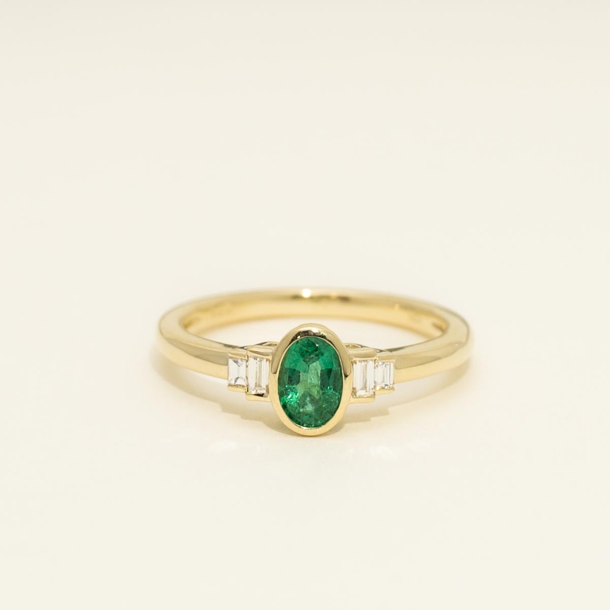 Oval Emerald Bezel Ring in 14kt Yellow Gold with Diamonds (1/10ct tw)