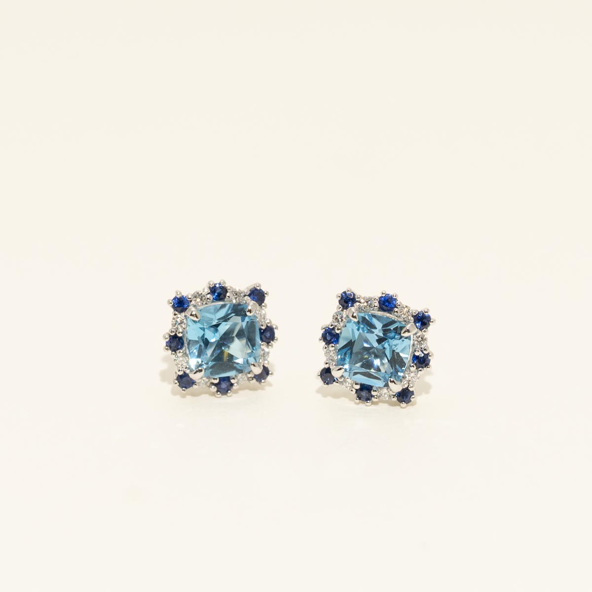 Cushion Cut Swiss Blue Topaz Stud Earrings with Diamond and Sapphire Halo in 14kt White Gold