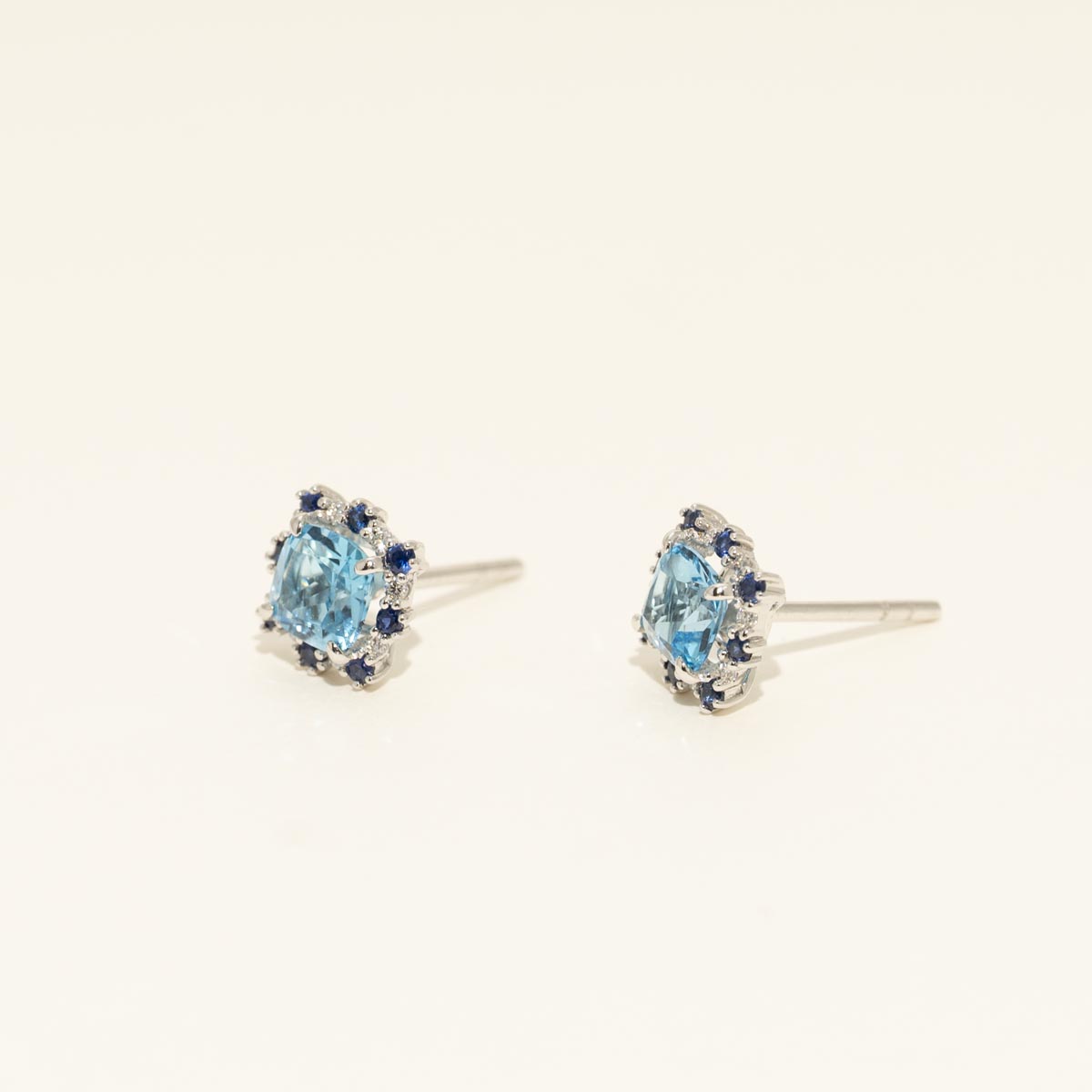 Cushion Cut Swiss Blue Topaz Stud Earrings with Diamond and Sapphire Halo in 14kt White Gold