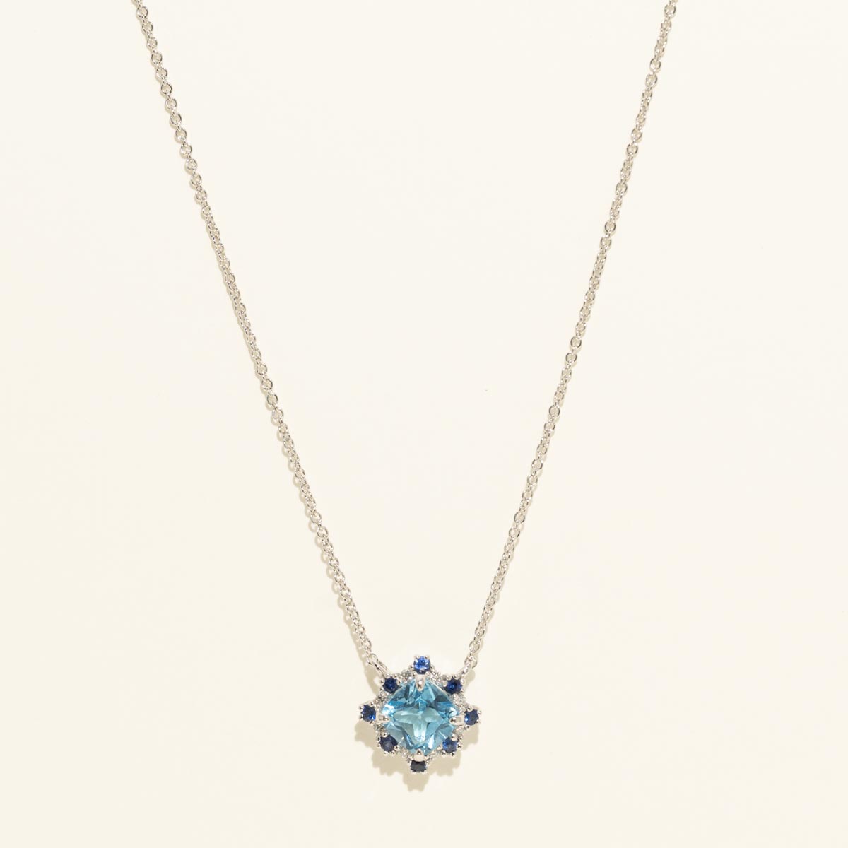 Cushion Cut Swiss Blue Topaz Necklace with Diamond and Sapphire Halo in 14kt White Gold