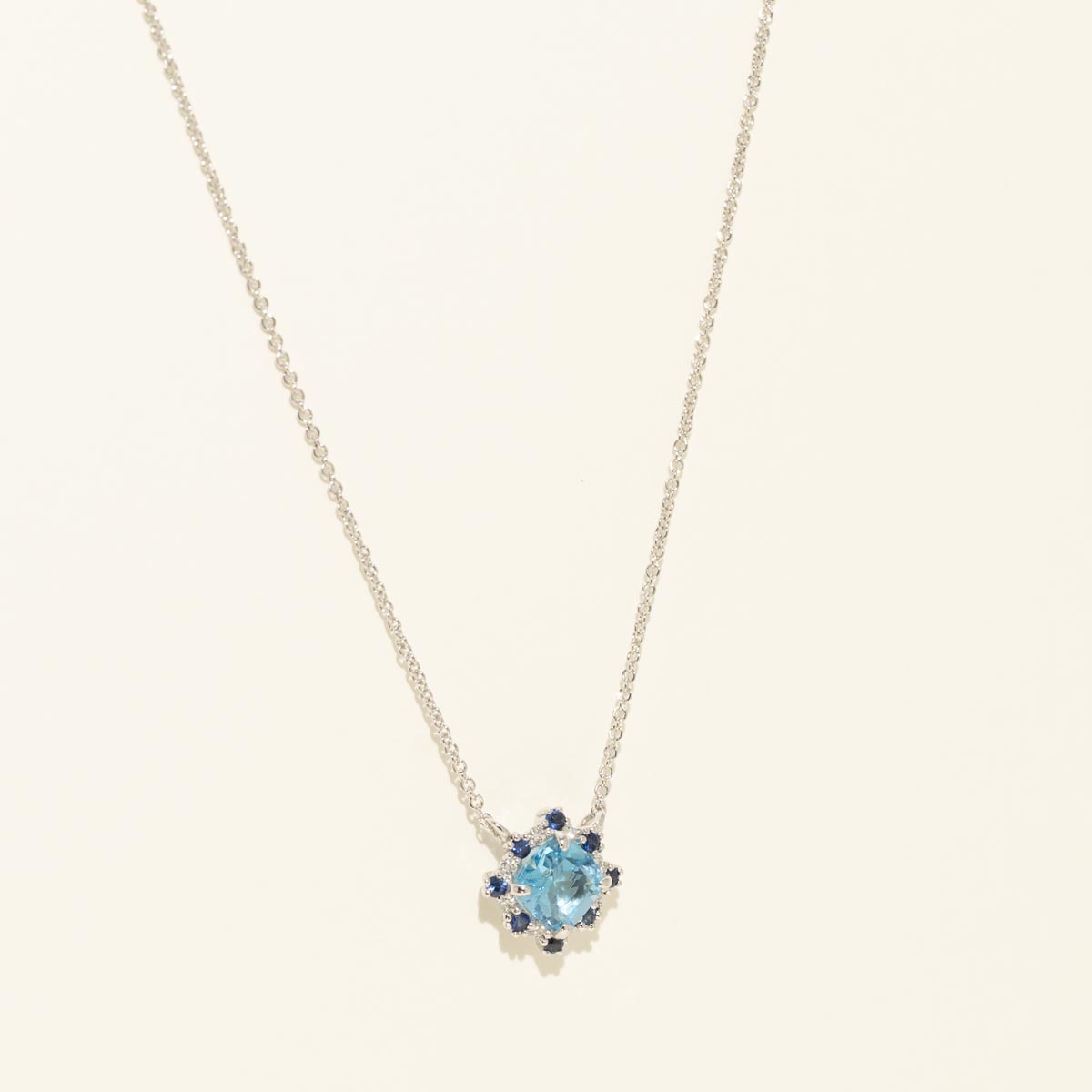 Cushion Cut Swiss Blue Topaz Necklace with Diamond and Sapphire Halo in 14kt White Gold