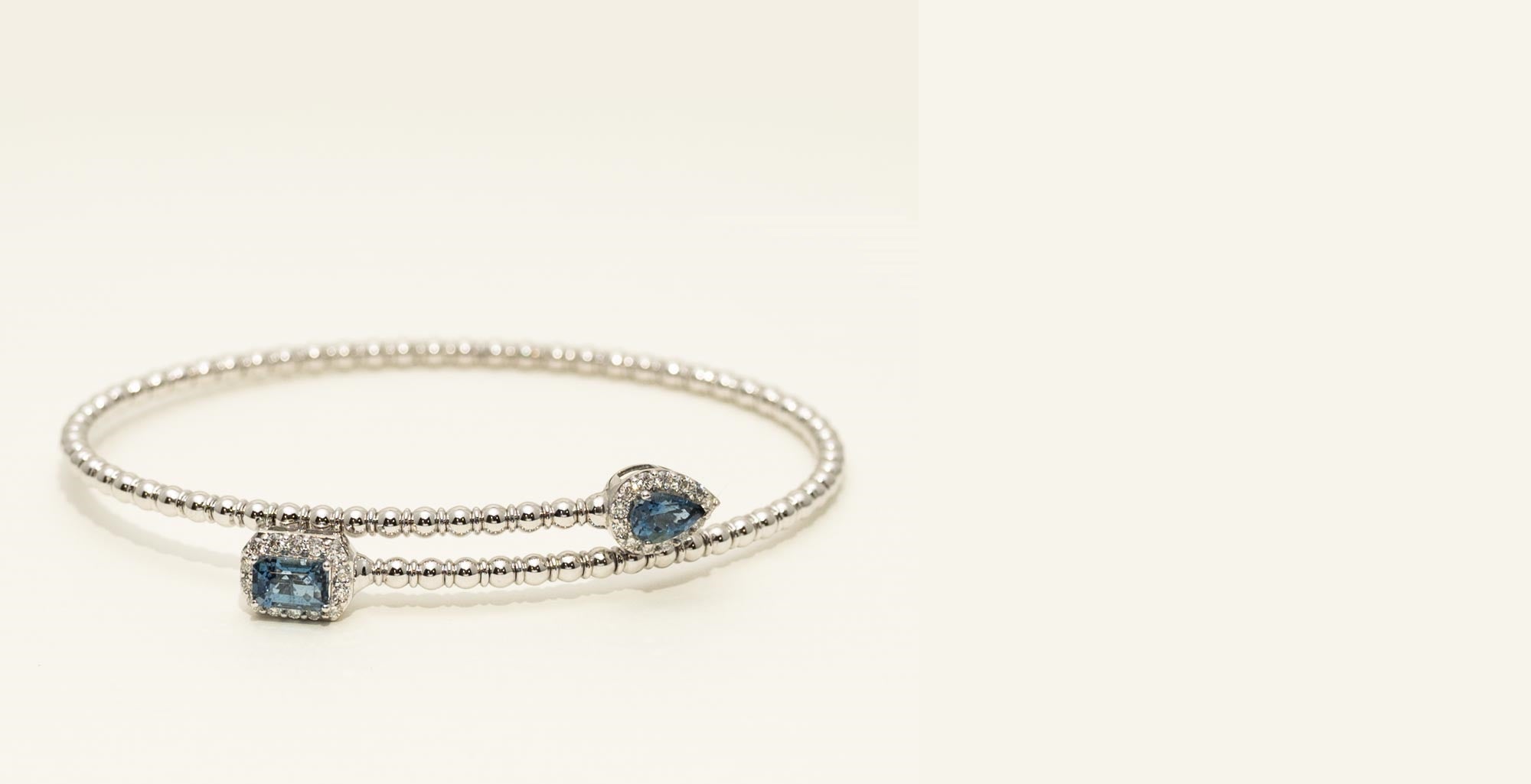Silver bracelet with blue gemstones on a white background