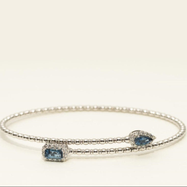 Silver bracelet with blue gemstones on a white background