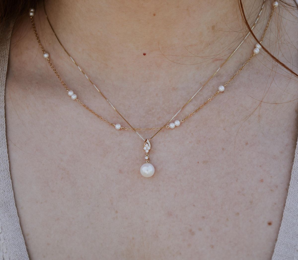 two pearl necklaces worn on a neck