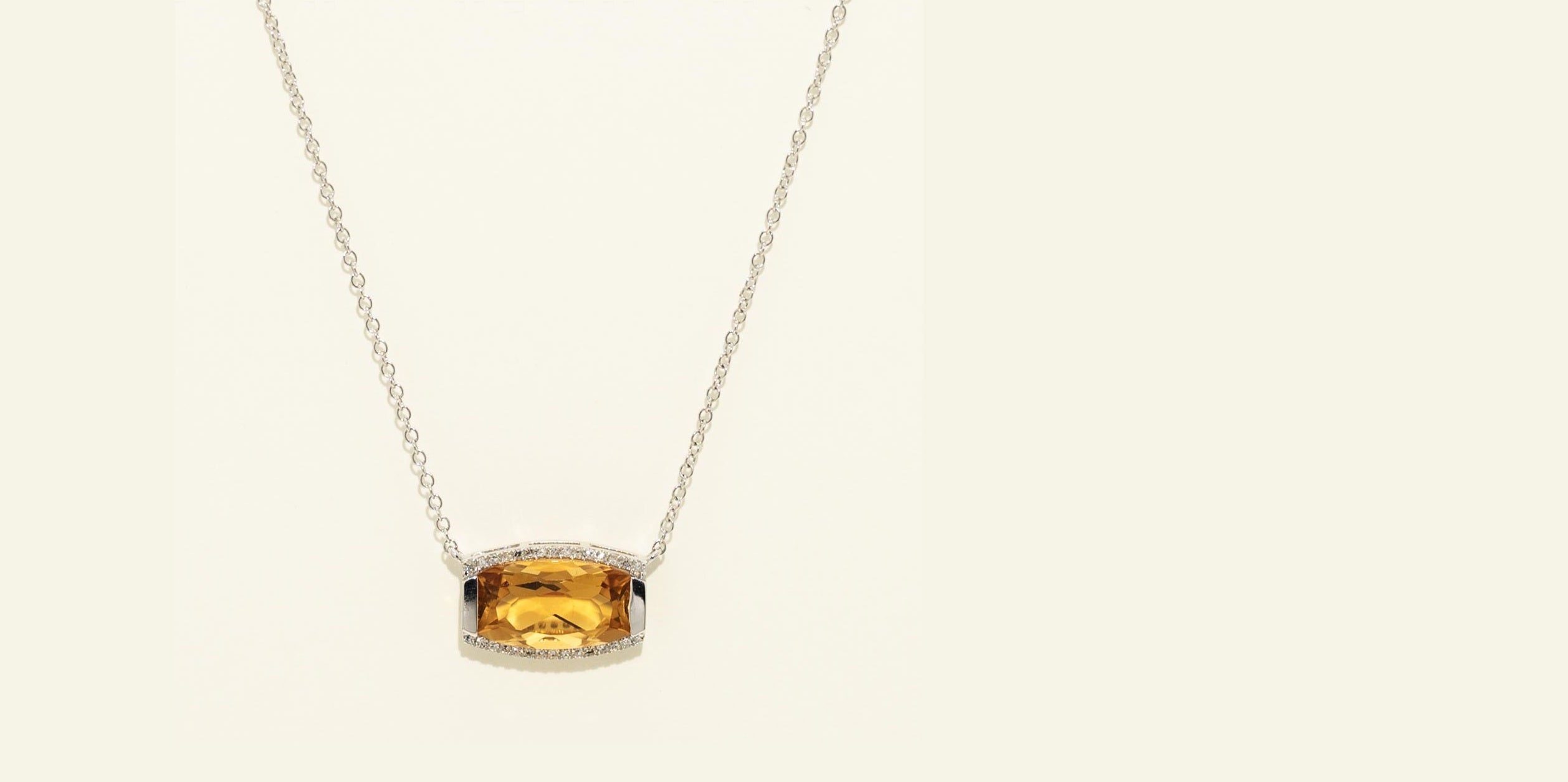 Necklace with a citrine pendant on a beige background