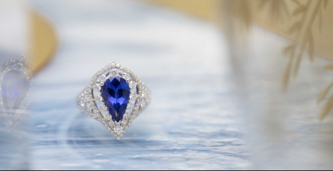 Ring with a blue gemstone on a blurred background