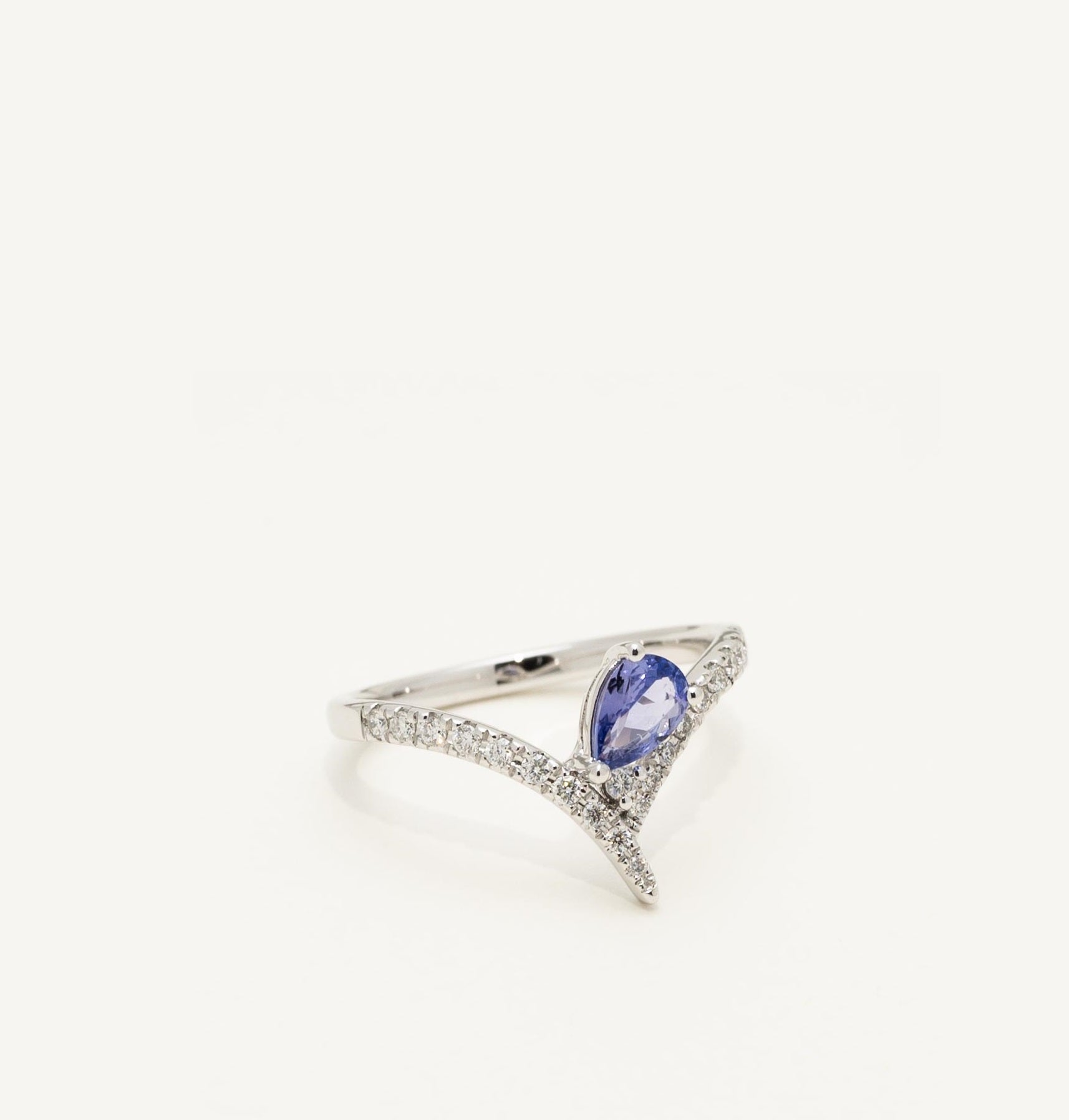 Silver ring with a blue gemstone on a white background