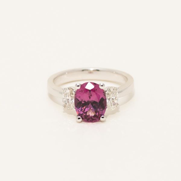Silver ring with a pink gemstone on a white background