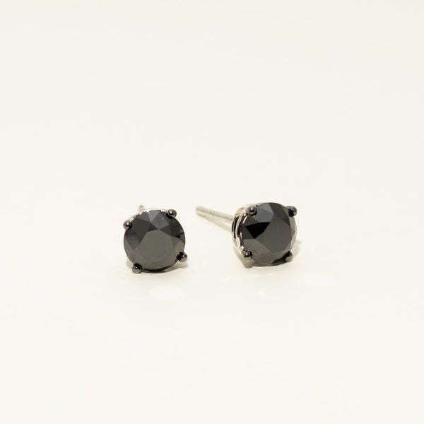 Pair of black stud earrings on a white background