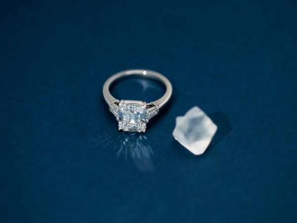 engagement ring with clear stone and model of rough 