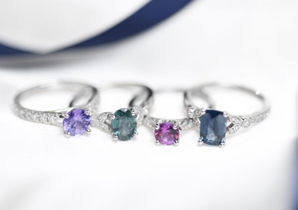 Three silver rings with gemstones on a white background
