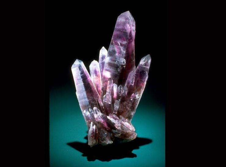 Group of purple crystal formations on a black background
