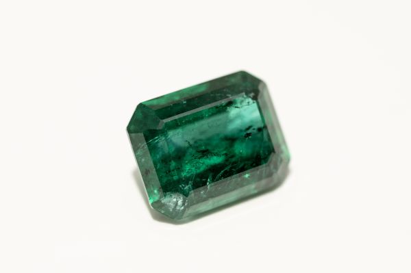 Green emerald gemstone on a white background