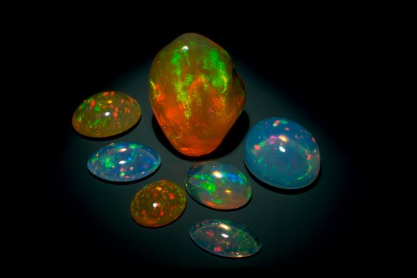 Collection of colorful opal stones on a dark background