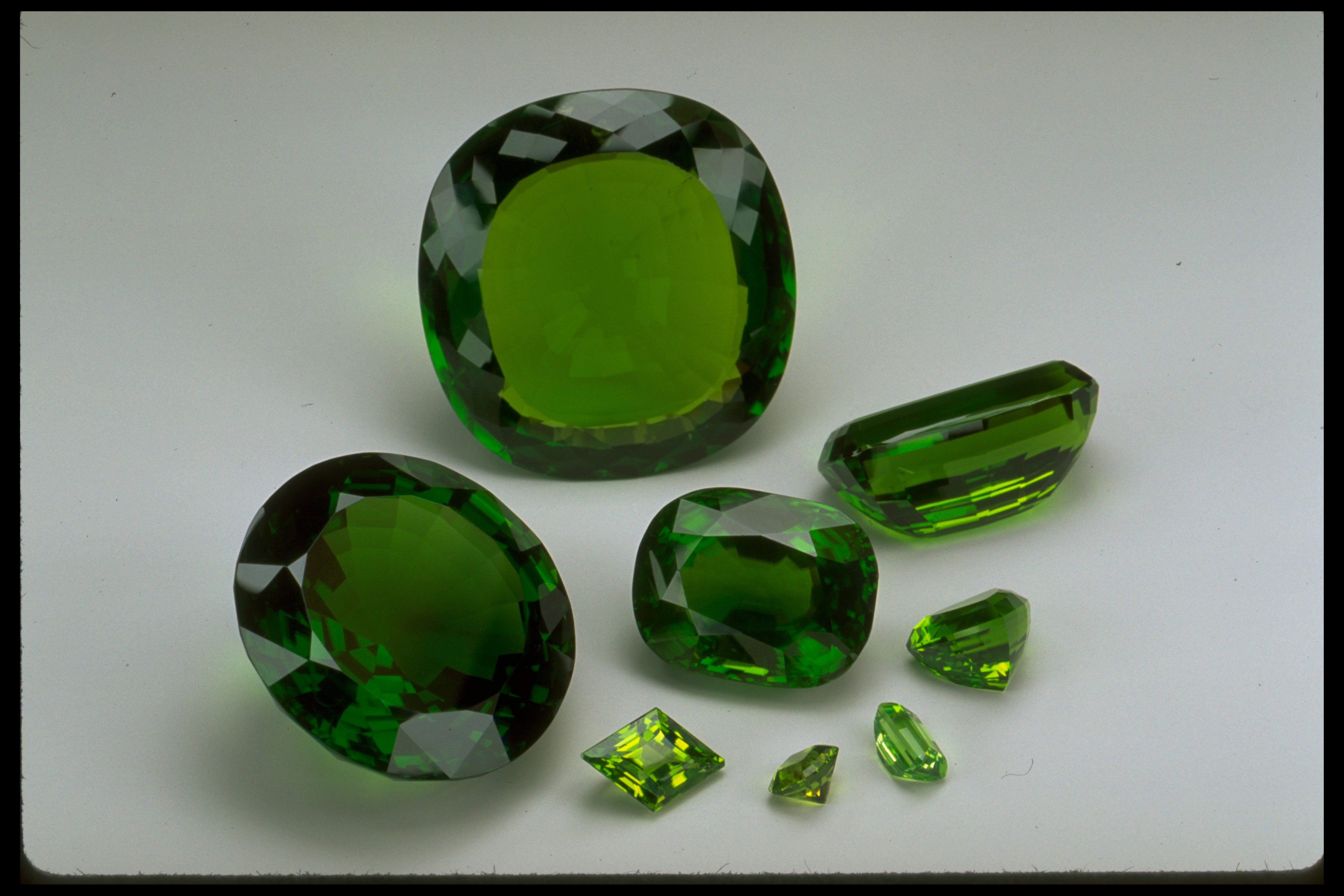 Collection of green gemstones on a white background