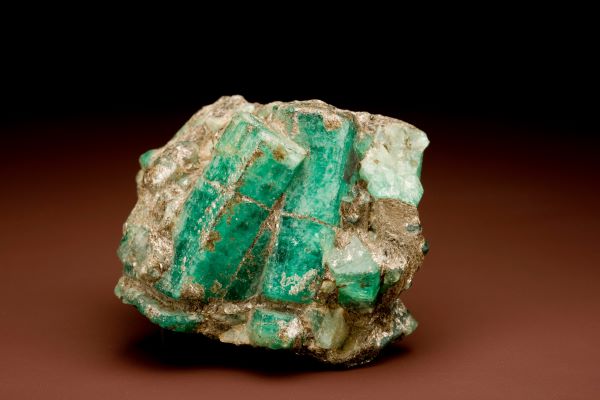 Green mineral specimen on a brown background