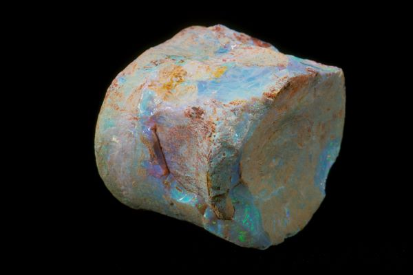 Raw opal stone on a black background